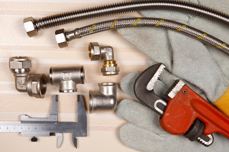 Plumber working on pipes in a Hackney home